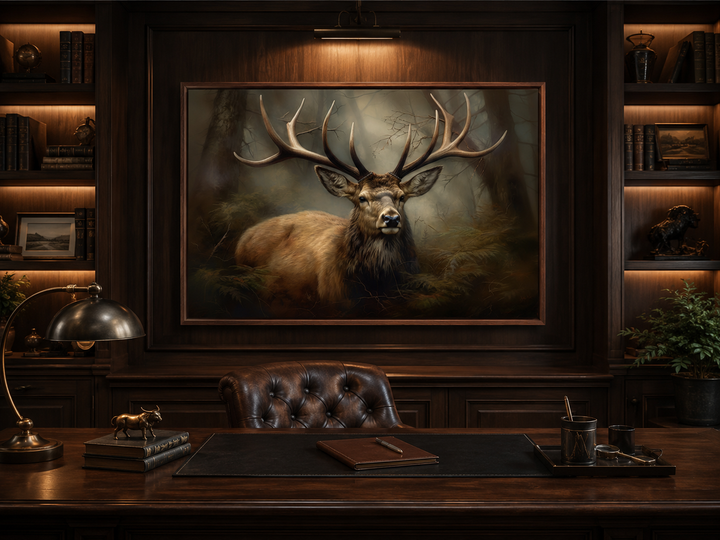 Framed canvas wall art of a majestic stag in a foggy forest, hung in a rustic wood-paneled office.
