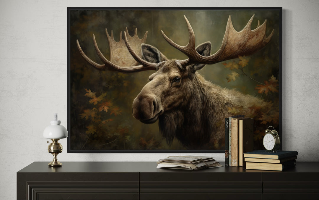 Majestic bull moose in autumn forest framed canvas wall art displayed above a dark wood dresser.