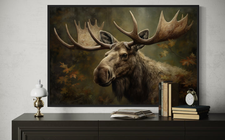 Majestic bull moose in autumn forest framed canvas wall art displayed above a dark wood dresser.
