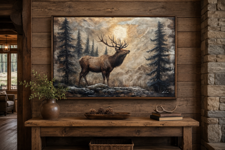 Rustic framed canvas wall art of an elk in a winter forest, displayed above a wooden console table.
