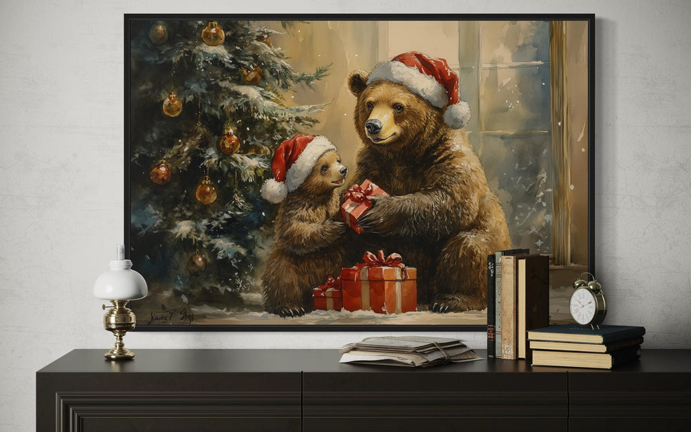 Mama bear and cub in Santa hats exchanging gifts by a Christmas tree in a framed wall art piece.
