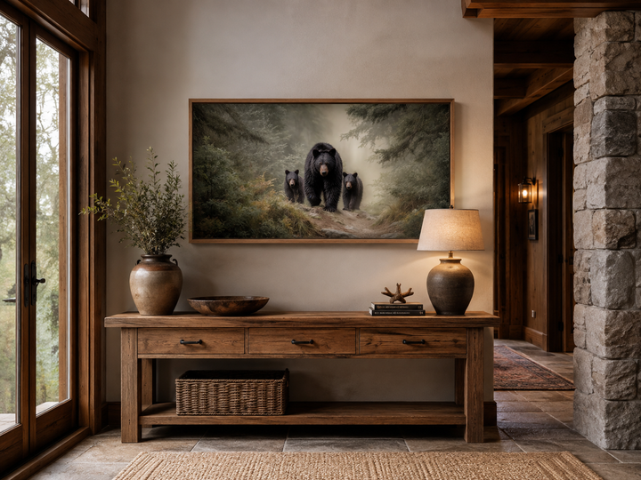 Mama bear and two cubs in a misty pine forest canvas wall art above a rustic wooden console table.