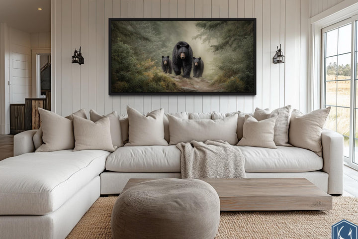 Mama Bear and Cubs in a misty pine forest canvas wall art hanging above a modern sectional sofa.