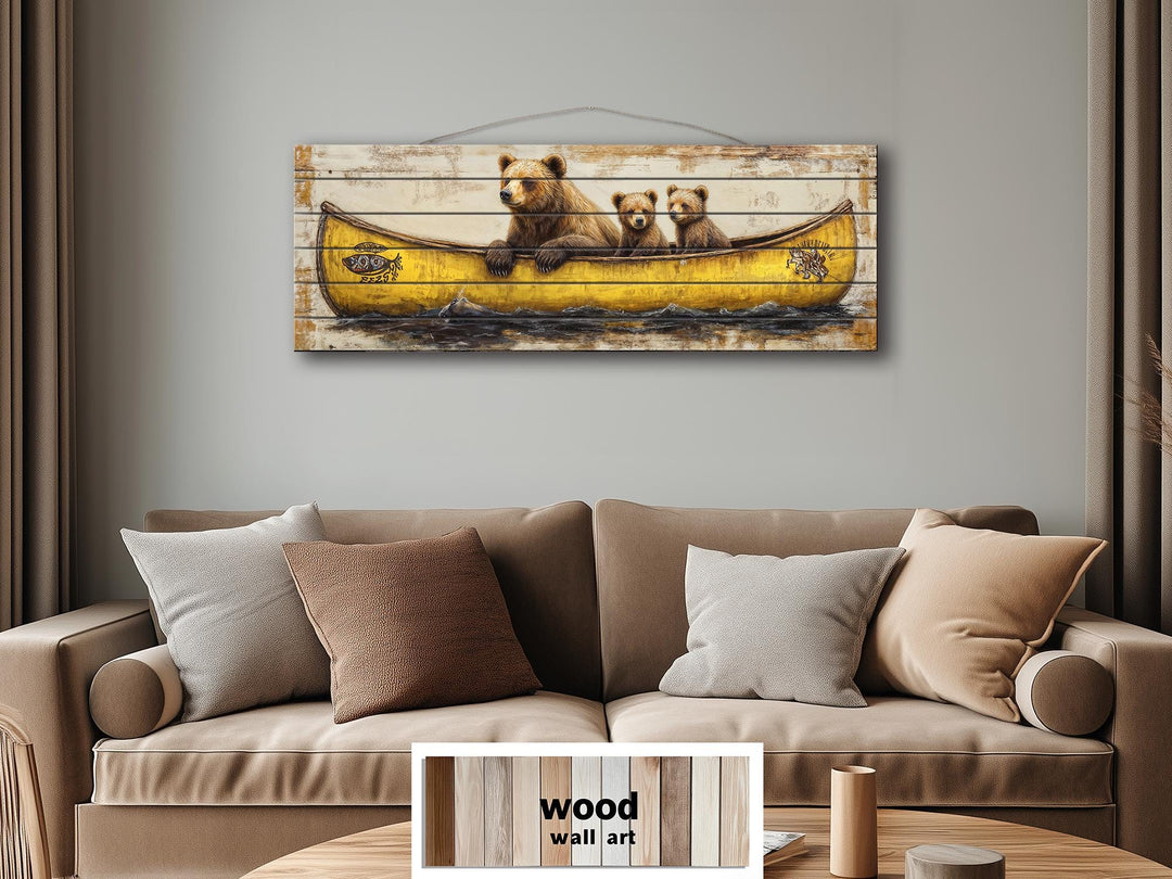 Mama bear and cubs in a yellow canoe printed on horizontal wood planks hanging above a sofa.