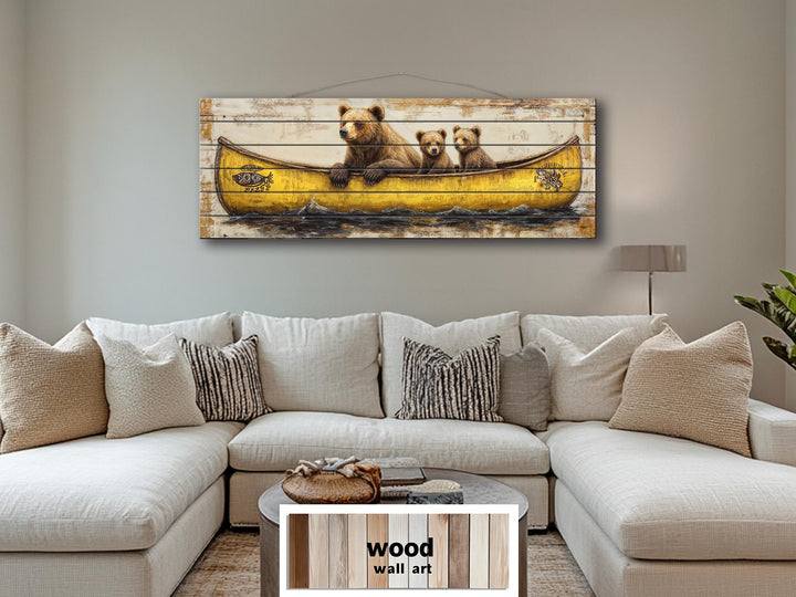Mama bear and cubs in a yellow canoe printed on horizontal wood planks above a white sectional sofa.