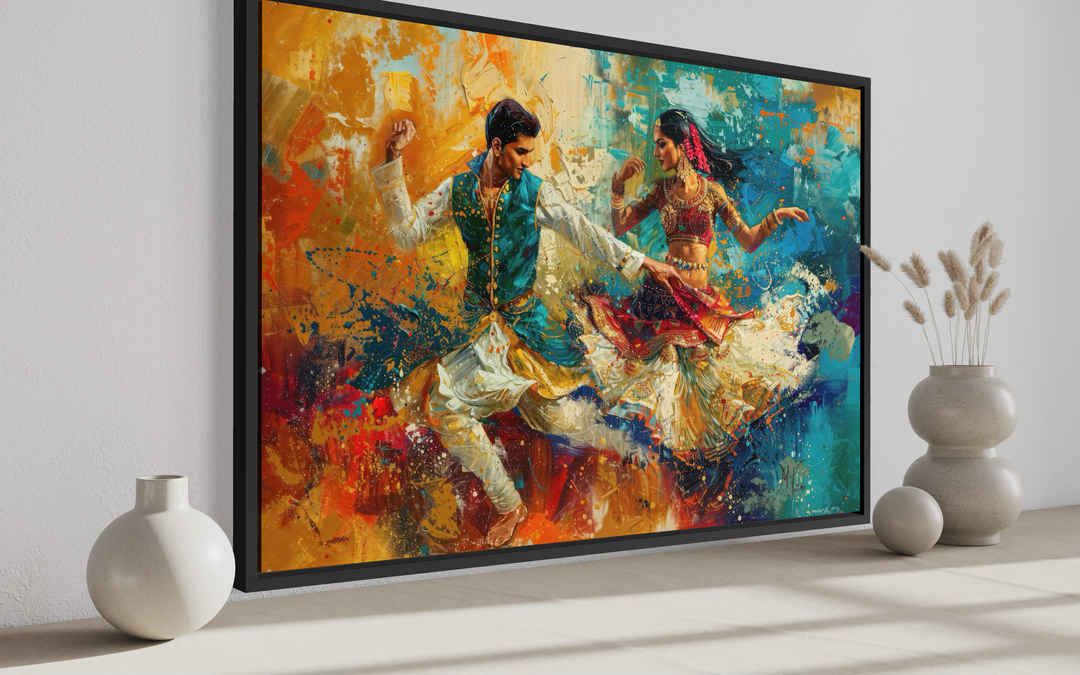 Framed canvas wall art featuring a vibrant painting of a man and woman dancing in Bollywood style.