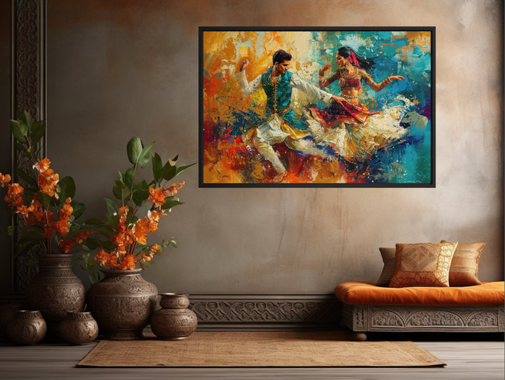Framed canvas wall art of a man and woman in traditional attire dancing in a vibrant Bollywood style.