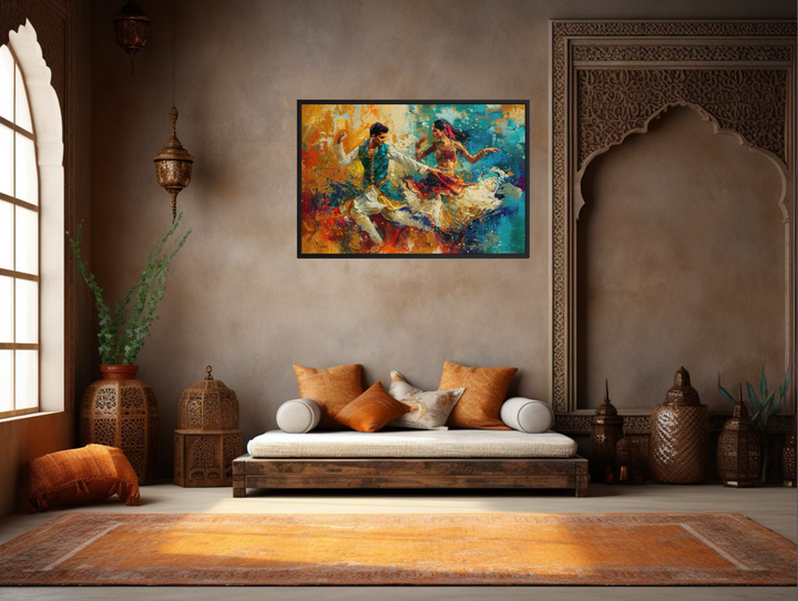 Framed canvas wall art of a man and woman dancing in vibrant Bollywood style on a neutral wall.