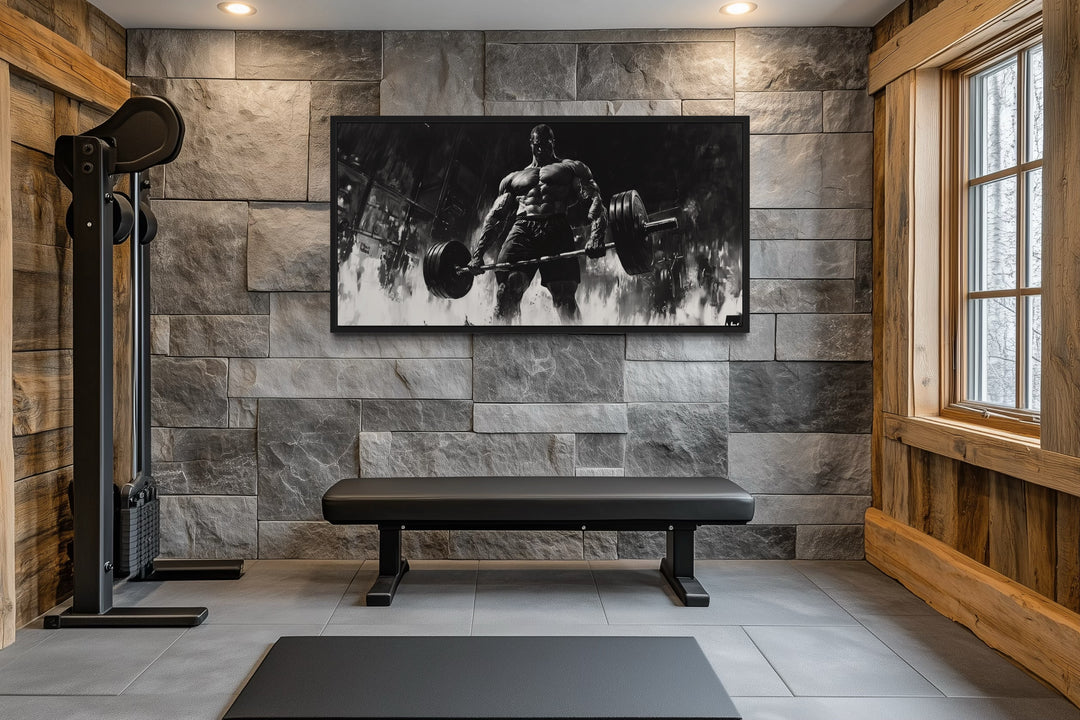 Man doing deadlift motivational black and white framed canvas wall art in a modern home gym.