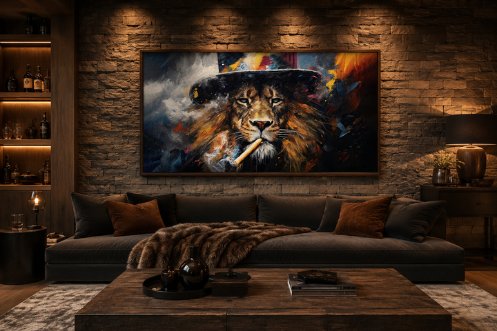 Framed canvas print of a lion smoking a cigar in a hat, hung above a sofa in a dark, moody room.