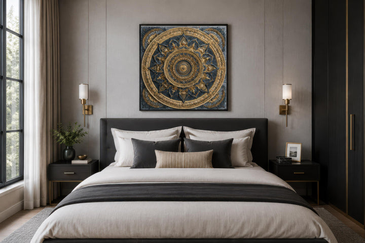 Intricate gold and blue mandala canvas art centered above a modern bed in a neutral-toned bedroom.
