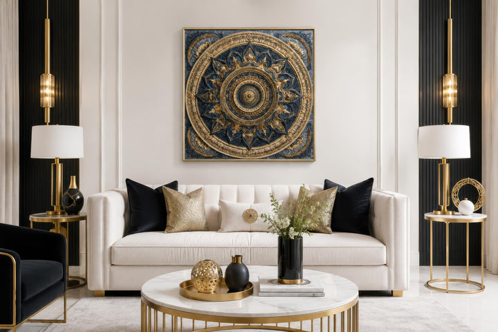 Intricate gold and blue mandala canvas art centered above a white sofa in a luxury living room.