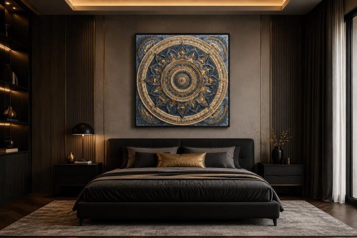 Intricate gold and blue mandala canvas art centered above a modern black bed in a luxury bedroom.
