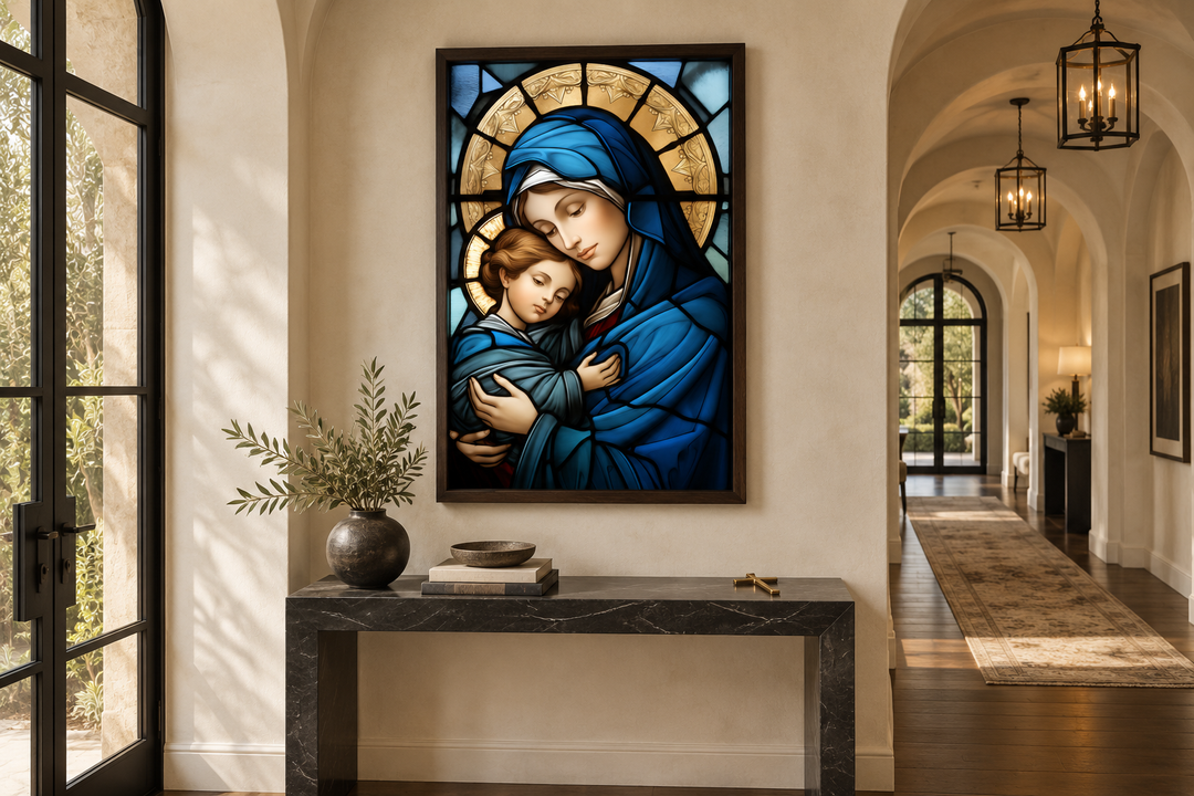Framed stained glass style canvas art of Mary holding Baby Jesus, displayed above a console table.