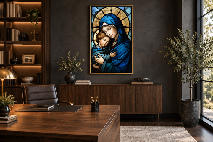 Framed stained glass style canvas art of Maria and Baby Jesus in a dark, modern office setting.