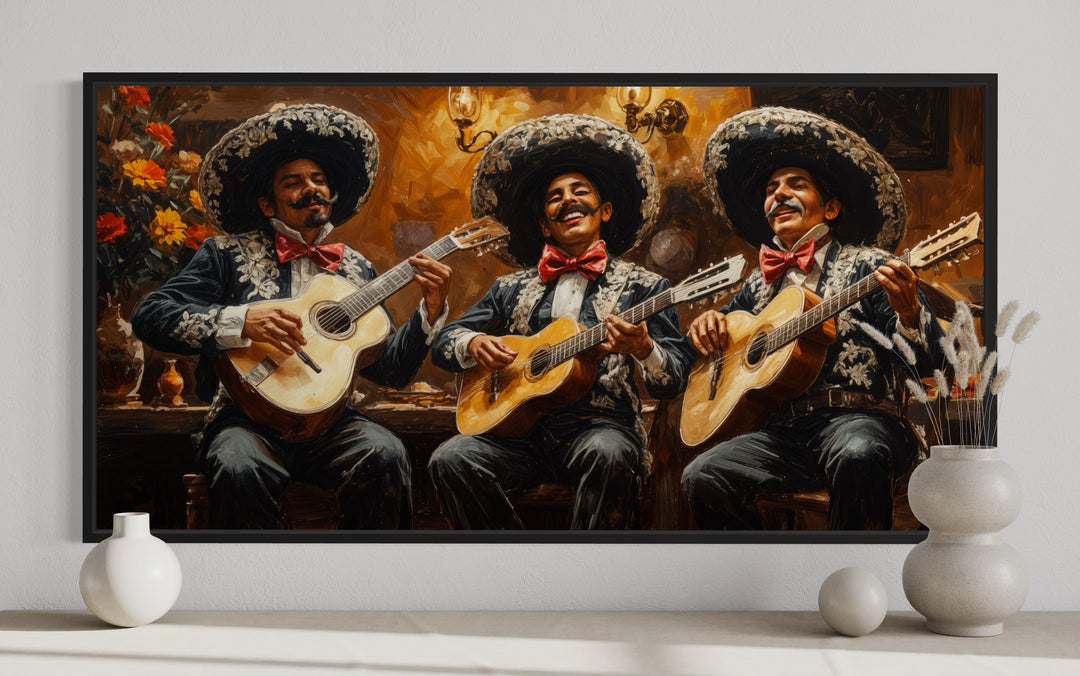 Framed canvas wall art of three mariachi musicians in traditional attire playing guitars.