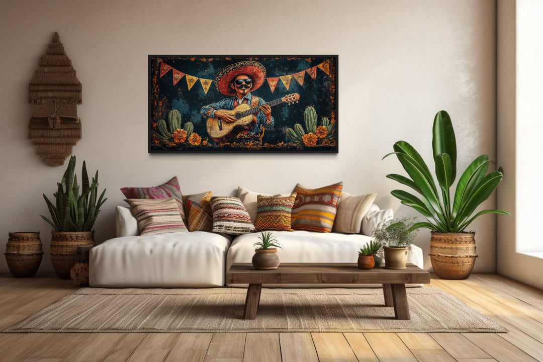 Mariachi musician in desert framed canvas wall art hanging above a white sofa in a living room.