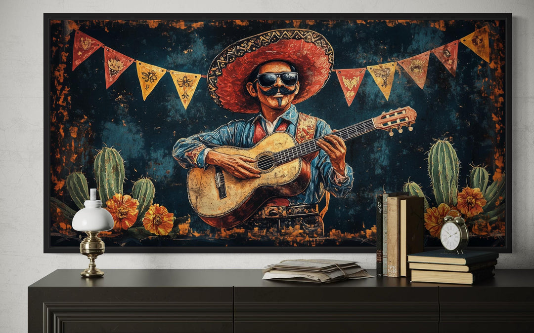 Framed canvas wall art of a mariachi musician with a guitar and sombrero in a desert setting.