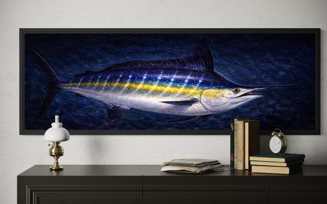 Horizontal canvas print of a blue marlin swimming in a dark ocean, framed and hung above a console.