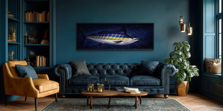 Long horizontal canvas print of a blue marlin swimming in a dark ocean, hung in a modern living room.