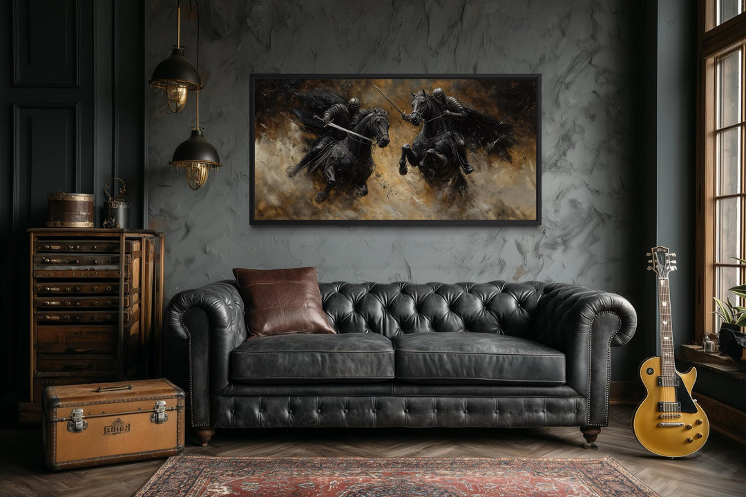 A horizontal framed canvas painting of two medieval knights dueling on horseback in a dark room.