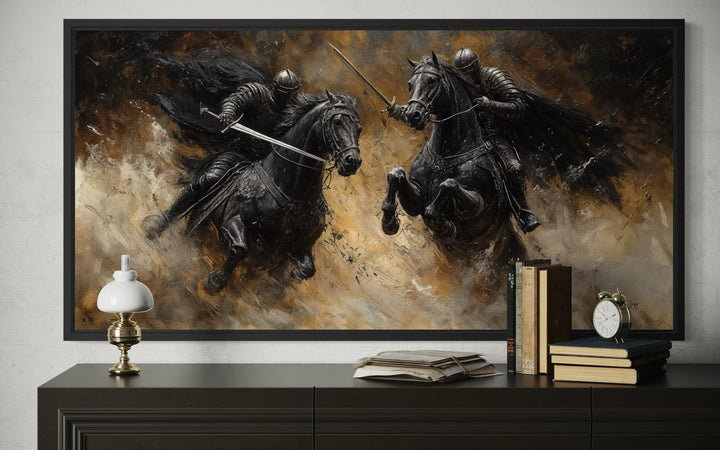 Framed horizontal canvas painting of two medieval knights in a dramatic duel on black horses.