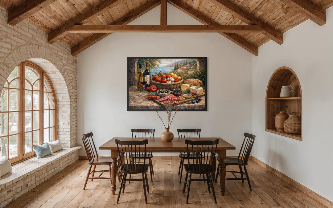 A framed Mediterranean still life canvas print hangs in a rustic dining room with wooden beams.