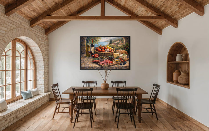 A framed Mediterranean still life canvas print hangs in a rustic dining room with wooden beams.