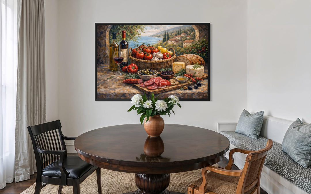 A framed Mediterranean still life canvas print hangs in a rustic dining room above a round table.