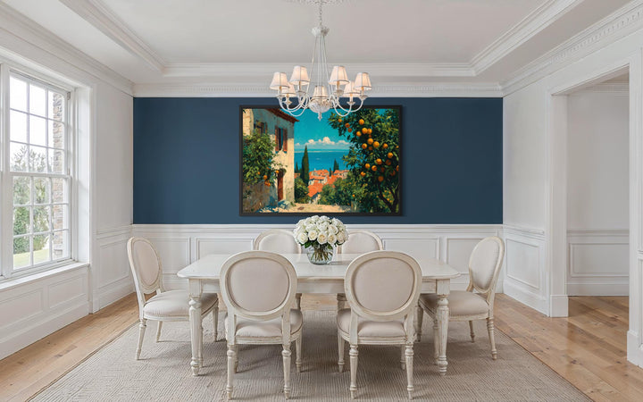 Mediterranean village canvas wall art with orange trees displayed in a classic blue dining room.