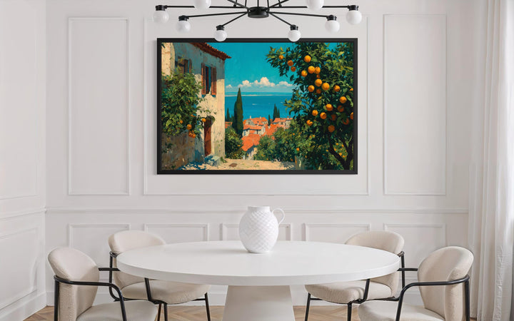 Mediterranean village canvas wall art with orange trees hanging in a modern white dining room.