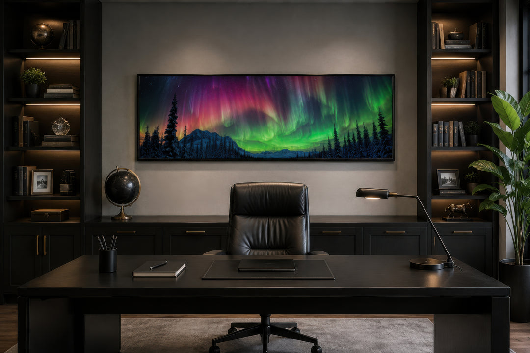 Long horizontal framed canvas wall art of the Aurora Borealis above a dark wood office desk.