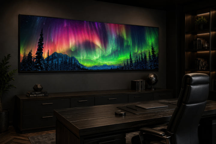 Long horizontal framed canvas wall art of the Aurora Borealis above a dark wood desk in an office.