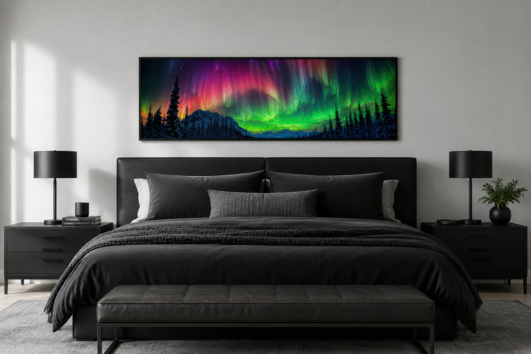 Long horizontal framed canvas of the Aurora Borealis above a black bed in a modern bedroom.