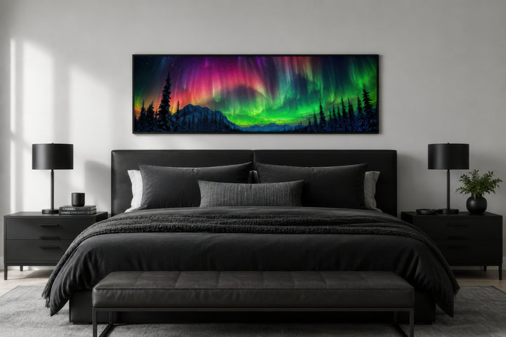Long horizontal framed canvas of the Aurora Borealis above a black bed in a modern bedroom.