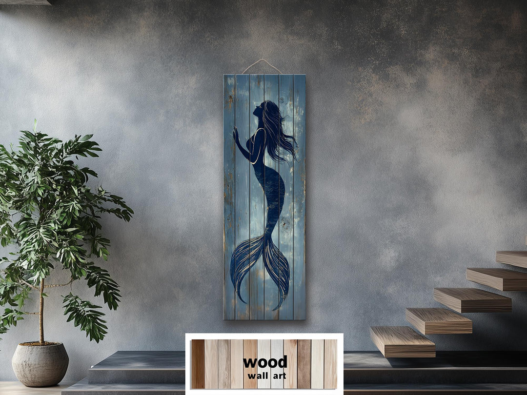 Tall narrow wood wall art featuring a blue mermaid silhouette on weathered blue planks.