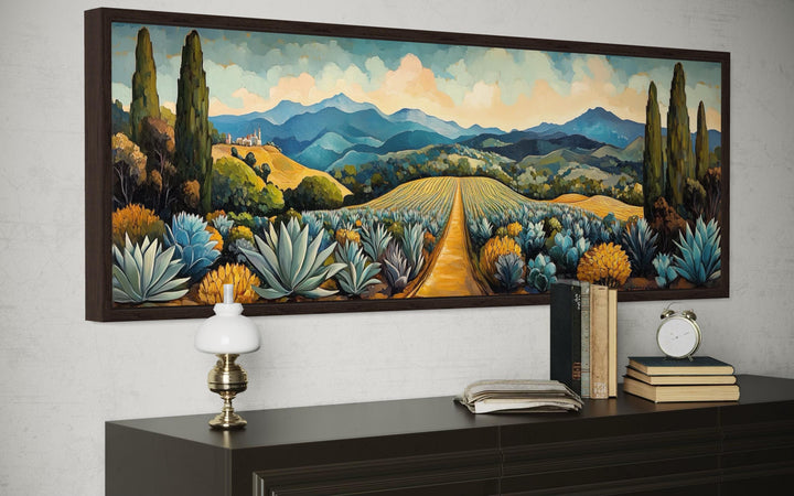 Panoramic canvas wall art of a Mexican agave field with golden paths and blue mountains.