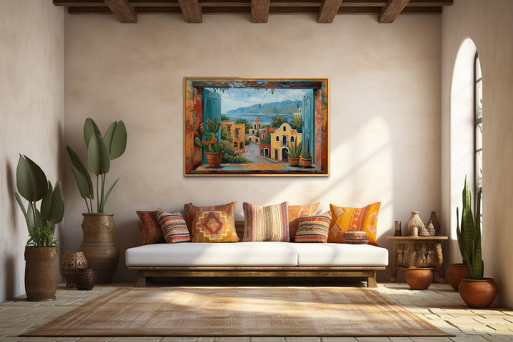Mexican Village Window View Framed Canvas Wall Art hanging in a rustic, sunlit living room.