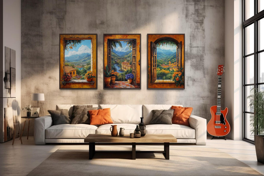 Set of three Mexican window view canvas prints showing colorful hacienda landscapes over a sofa.