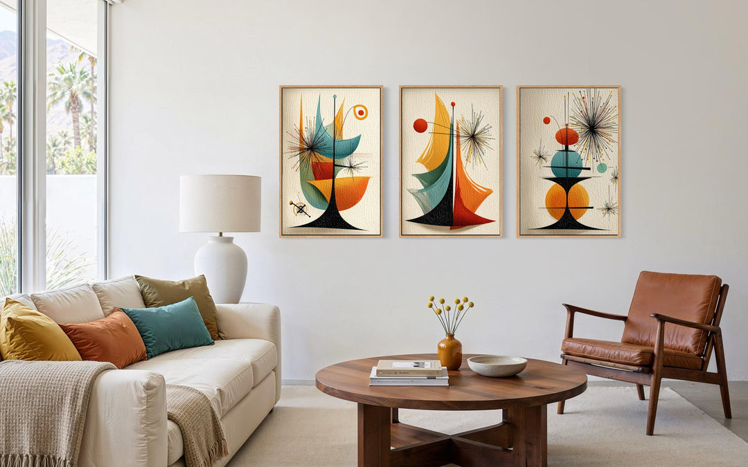 Set of three mid-century modern abstract prints with retro geometric shapes in a living room.