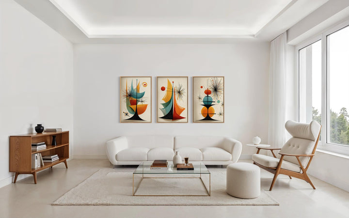 Set of three mid-century modern abstract canvas prints with retro geometric shapes in a living room.