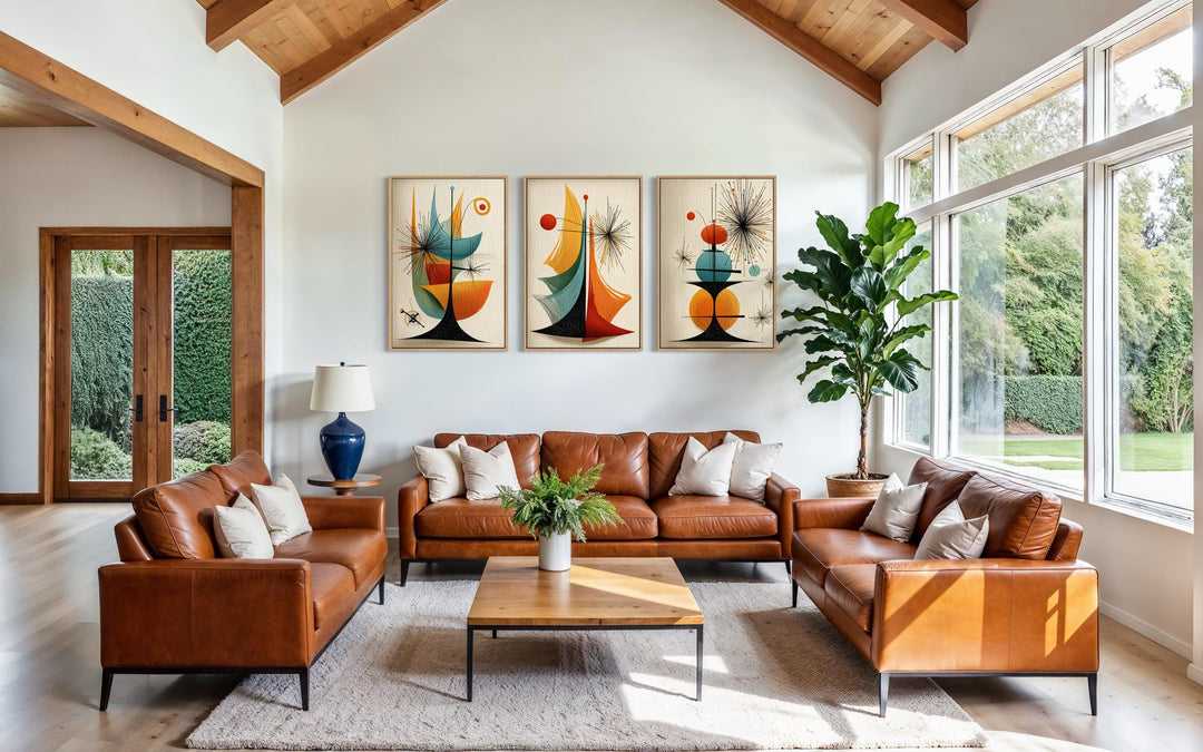 Set of three mid-century modern abstract canvas prints with retro geometric shapes in a living room.