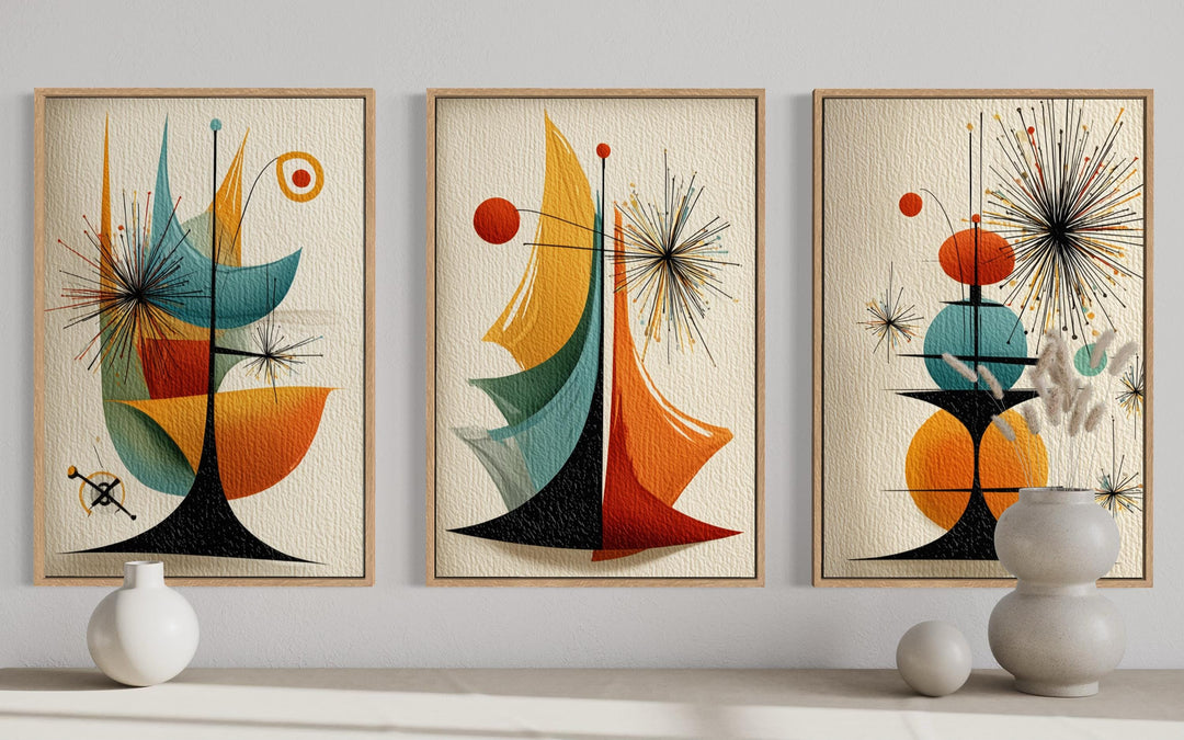 Three framed mid-century modern abstract prints with retro geometric shapes and atomic-style motifs.