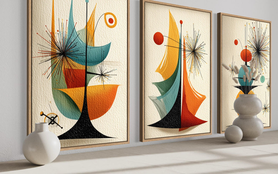 Three vertical mid-century modern abstract canvas prints featuring retro geometric and atomic shapes.