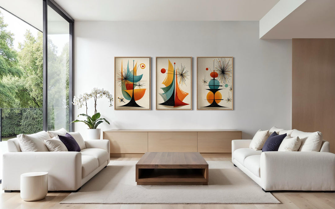 Set of three mid-century modern abstract canvas prints with retro geometric shapes in a living room.
