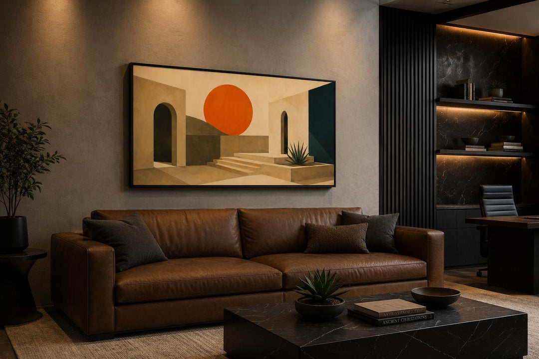 Abstract sunset art canvas with terracotta archways and a bold orange sun over a leather sofa.