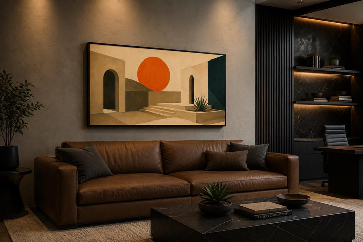 Abstract sunset art canvas with terracotta archways and a bold orange sun over a leather sofa.