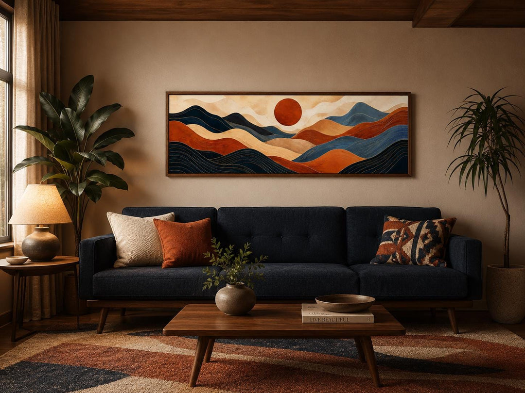 Long horizontal abstract wall art of burnt orange and navy blue mountains under a red sun.