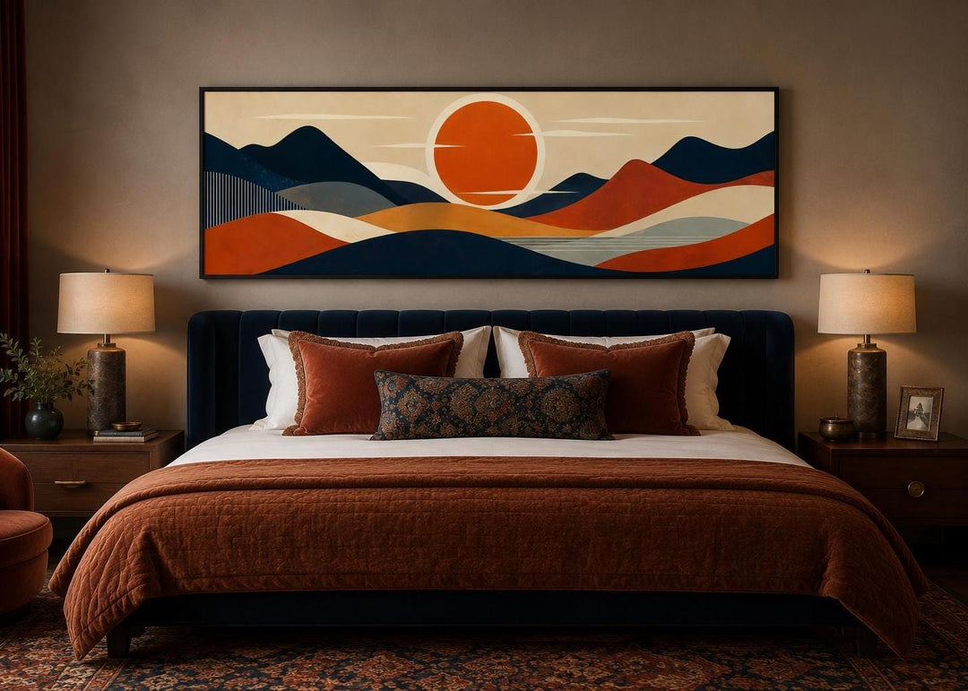Mid-century modern navy and orange mountain sunset canvas print hanging above a bed.
