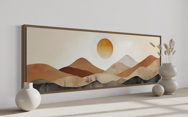 Mid century modern long narrow canvas art featuring a neutral brown and beige mountain sunset.